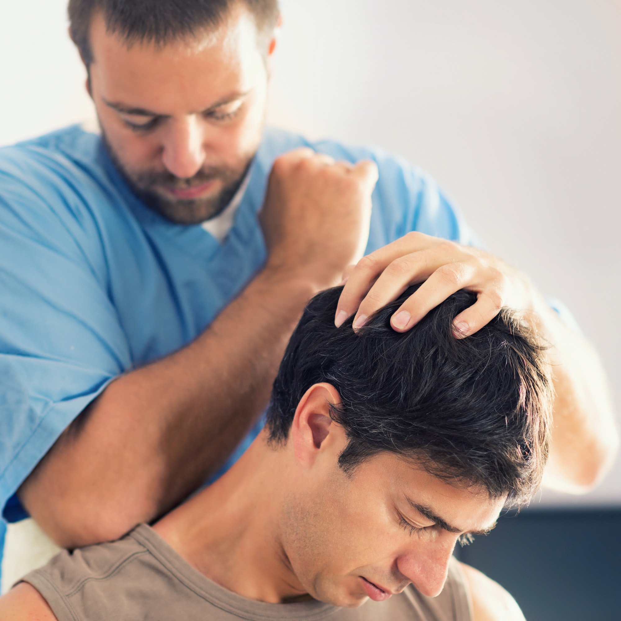 Physiotherapist Working With Patient Neck And Shoulders